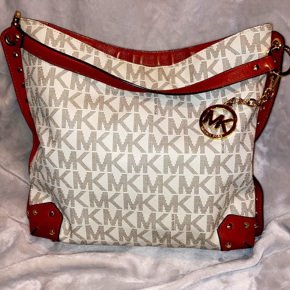 Michael Kors authentic bag adorned with classic logo Gold studs and purse charm